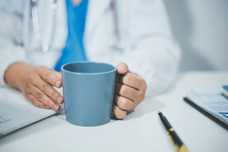 Female scientist holding coffee mug in laboratoryの写真素材