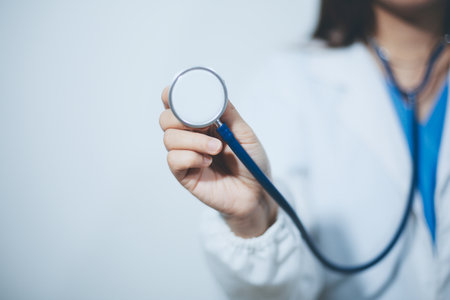 A young doctor holding an stethoscopeの写真素材