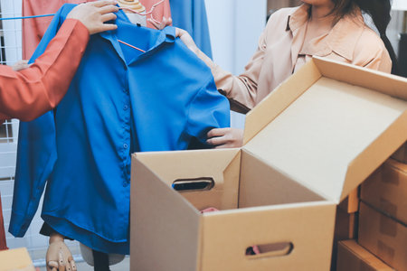 Portrait of Starting small businesses SME owners, two Asian woman check online orders Selling products working with boxs freelance work at home office, sme business online small medium enterpriseの写真素材