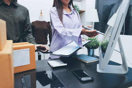 Portrait of Starting small businesses SME owners, two Asian woman check online orders Selling products working with boxs freelance work at home office, sme business online small medium enterpriseの写真素材
