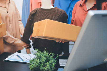 Portrait of Starting small businesses SME owners, two Asian woman check online orders Selling products working with boxs freelance work at home office, sme business online small medium enterpriseの写真素材