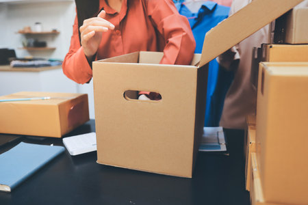 Portrait of Starting small businesses SME owners, two Asian woman check online orders Selling products working with boxs freelance work at home office, sme business online small medium enterpriseの写真素材