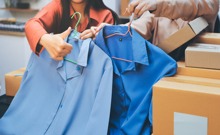 Portrait of Starting small businesses SME owners, two Asian woman check online orders Selling products working with boxs freelance work at home office, sme business online small medium enterpriseの写真素材