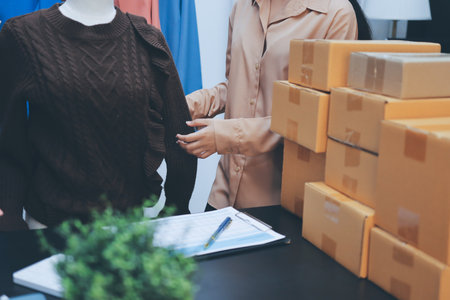 Portrait of Starting small businesses SME owners, two Asian woman check online orders Selling products working with boxs freelance work at home office, sme business online small medium enterpriseの写真素材
