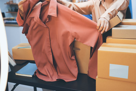 Portrait of Starting small businesses SME owners, two Asian woman check online orders Selling products working with boxs freelance work at home office, sme business online small medium enterpriseの写真素材