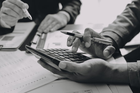 Accounting company provide finance and taxation planning for profitable cash flow, Auditor and accountant team working in office, analyze financial data and accounting record with calculator.Insightの写真素材