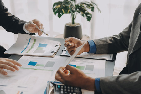 Accounting company provide finance and taxation planning for profitable cash flow, Auditor and accountant team working in office, analyze financial data and accounting record with calculator.Insightの写真素材