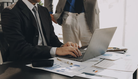 Accounting company provide finance and taxation planning for profitable cash flow, Auditor and accountant team working in office, analyze financial data and accounting record with calculator.Insightの写真素材