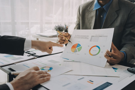 Accounting company provide finance and taxation planning for profitable cash flow, Auditor and accountant team working in office, analyze financial data and accounting record with calculator.Insightの写真素材