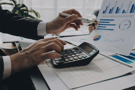 Accounting company provide finance and taxation planning for profitable cash flow, Auditor and accountant team working in office, analyze financial data and accounting record with calculator.Insightの写真素材