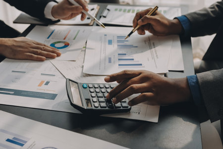 Accounting company provide finance and taxation planning for profitable cash flow, Auditor and accountant team working in office, analyze financial data and accounting record with calculator.Insightの写真素材