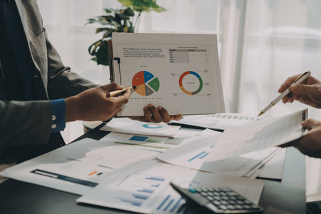 Accounting company provide finance and taxation planning for profitable cash flow, Auditor and accountant team working in office, analyze financial data and accounting record with calculator.Insightの写真素材