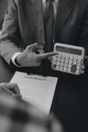 Car salesman gave the keys to the customers who signed the purchase contract legally, Successful completion of car sales, Purchase contract and key delivery.の写真素材