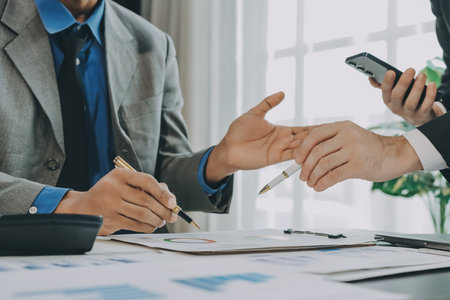 Accounting company provide finance and taxation planning for profitable cash flow, Auditor and accountant team working in office, analyze financial data and accounting record with calculator.Insightの写真素材