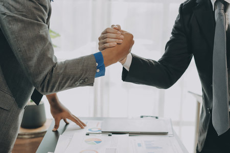 Business handshake for teamwork of business merger and acquisition,successful negotiate,hand shake,two businessman shake hand with partner to celebration partnership and business deal conceptの写真素材