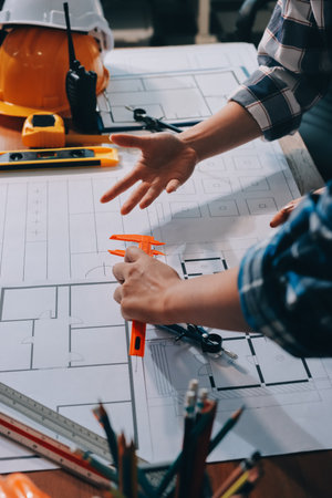Construction and structure concept of engineer working drawing on blueprint meeting for project...