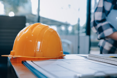 Construction and structure concept of engineer working drawing on blueprint meeting for project working with partner on model building and engineering tools in working site, construction concept.の写真素材