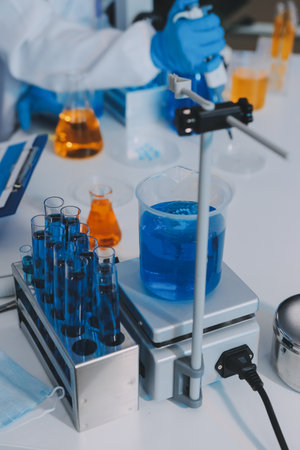 Collaboration, tablet or science with people in lab together for research or development. Innovation, tech and microscope with scientist team in clinical trial for planning or medical investigationの写真素材