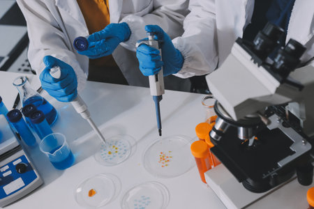 Collaboration, tablet or science with people in lab together for research or development. Innovation, tech and microscope with scientist team in clinical trial for planning or medical investigationの写真素材