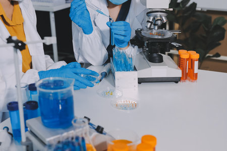 Collaboration, tablet or science with people in lab together for research or development. Innovation, tech and microscope with scientist team in clinical trial for planning or medical investigationの写真素材