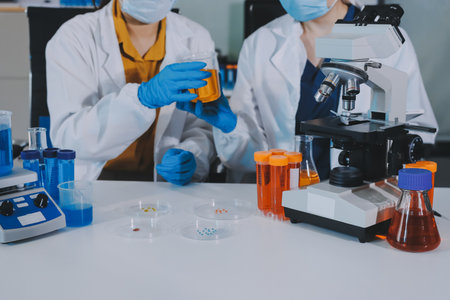 Collaboration, tablet or science with people in lab together for research or development. Innovation, tech and microscope with scientist team in clinical trial for planning or medical investigationの写真素材