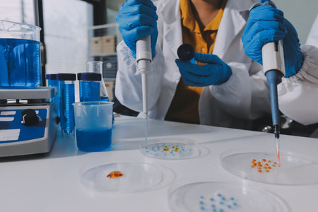 Collaboration, tablet or science with people in lab together for research or development. Innovation, tech and microscope with scientist team in clinical trial for planning or medical investigationの写真素材