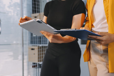 Construction and structure concept of engineer working drawing on blueprint meeting for project working with partner on model building and engineering tools in working site, construction concept.の写真素材