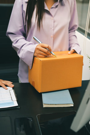 Portrait of Starting small businesses SME owners, two Asian woman check online orders Selling products working with boxs freelance work at home office, sme business online small medium enterpriseの写真素材