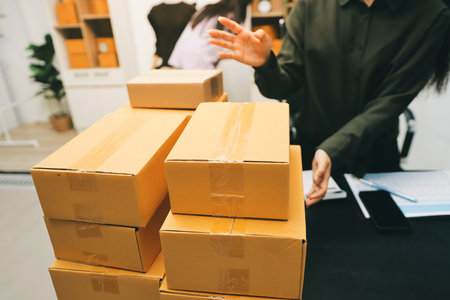 Portrait of Starting small businesses SME owners, two Asian woman check online orders Selling products working with boxs freelance work at home office, sme business online small medium enterpriseの写真素材