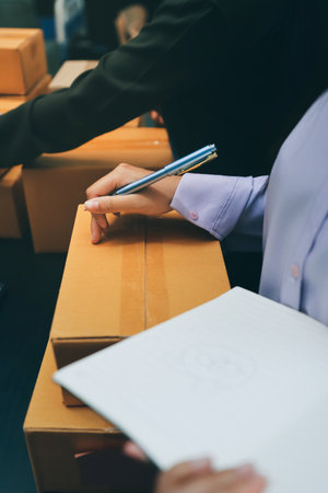 Portrait of Starting small businesses SME owners, two Asian woman check online orders Selling products working with boxs freelance work at home office, sme business online small medium enterpriseの写真素材