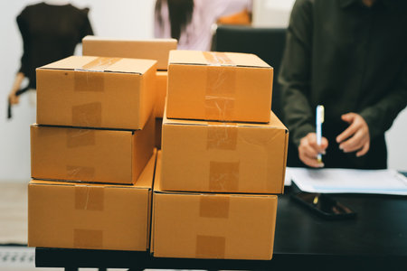 Portrait of Starting small businesses SME owners, two Asian woman check online orders Selling products working with boxs freelance work at home office, sme business online small medium enterpriseの写真素材