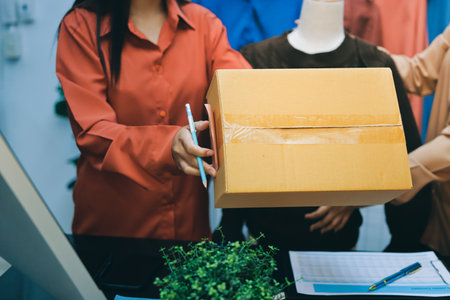 Portrait of Starting small businesses SME owners, two Asian woman check online orders Selling products working with boxs freelance work at home office, sme business online small medium enterpriseの写真素材