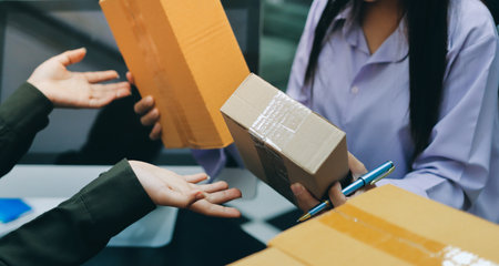 Portrait of Starting small businesses SME owners, two Asian woman check online orders Selling products working with boxs freelance work at home office, sme business online small medium enterpriseの写真素材