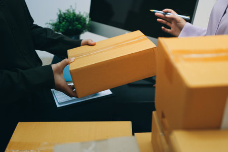 Portrait of Starting small businesses SME owners, two Asian woman check online orders Selling products working with boxs freelance work at home office, sme business online small medium enterpriseの写真素材
