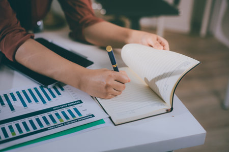 Portrait of young Hispanic professional business woman standing in office. Happy female company executive, smiling businesswoman entrepreneur corporate leader manager looking at camera using tabletの写真素材