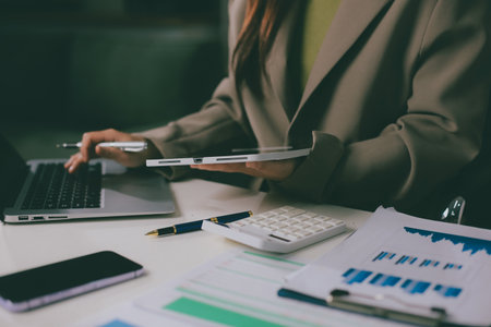 Portrait of young Hispanic professional business woman standing in office. Happy female company executive, smiling businesswoman entrepreneur corporate leader manager looking at camera using tabletの写真素材