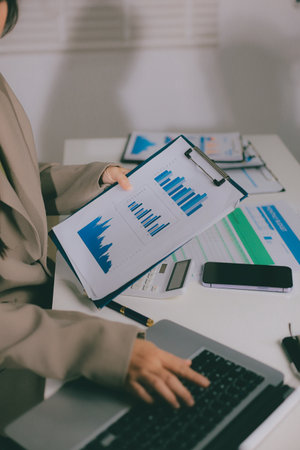 Portrait of young Hispanic professional business woman standing in office. Happy female company executive, smiling businesswoman entrepreneur corporate leader manager looking at camera using tabletの写真素材