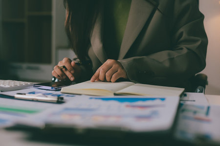 Portrait of young Hispanic professional business woman standing in office. Happy female company executive, smiling businesswoman entrepreneur corporate leader manager looking at camera using tabletの写真素材