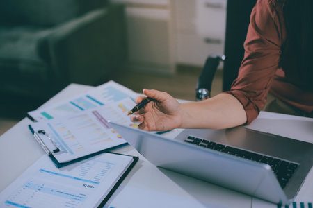 Portrait of young Hispanic professional business woman standing in office. Happy female company executive, smiling businesswoman entrepreneur corporate leader manager looking at camera using tabletの写真素材