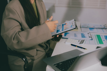 Portrait of young Hispanic professional business woman standing in office. Happy female company executive, smiling businesswoman entrepreneur corporate leader manager looking at camera using tabletの写真素材