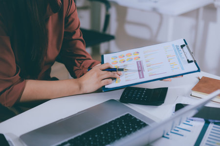 Portrait of young Hispanic professional business woman standing in office. Happy female company executive, smiling businesswoman entrepreneur corporate leader manager looking at camera using tabletの写真素材