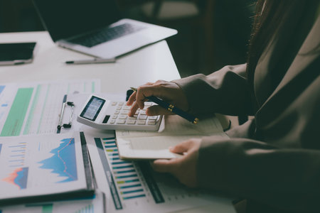 Portrait of young Hispanic professional business woman standing in office. Happy female company executive, smiling businesswoman entrepreneur corporate leader manager looking at camera using tabletの写真素材
