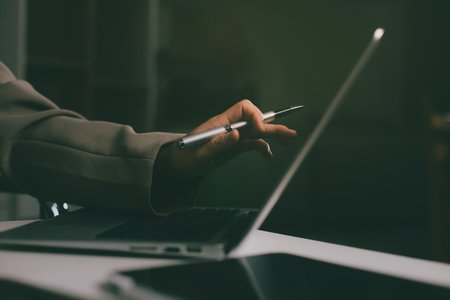 Portrait of young Hispanic professional business woman standing in office. Happy female company executive, smiling businesswoman entrepreneur corporate leader manager looking at camera using tabletの写真素材