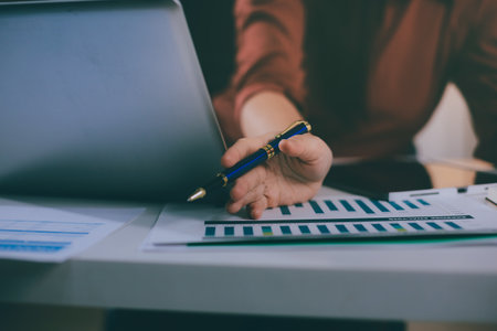 Portrait of young Hispanic professional business woman standing in office. Happy female company executive, smiling businesswoman entrepreneur corporate leader manager looking at camera using tabletの写真素材