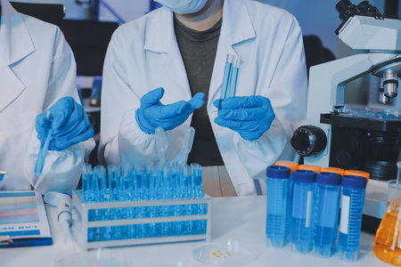 Collaboration, tablet or science with people in lab together for research or development. Innovation, tech and microscope with scientist team in clinical trial for planning or medical investigationの写真素材