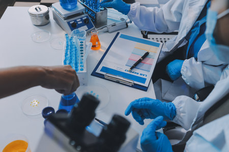 Collaboration, tablet or science with people in lab together for research or development. Innovation, tech and microscope with scientist team in clinical trial for planning or medical investigationの写真素材