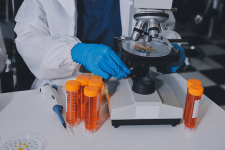 Collaboration, tablet or science with people in lab together for research or development. Innovation, tech and microscope with scientist team in clinical trial for planning or medical investigationの写真素材