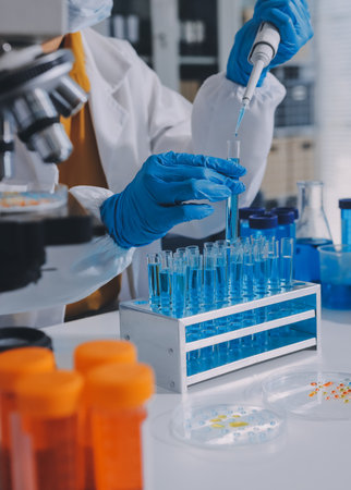 Collaboration, tablet or science with people in lab together for research or development. Innovation, tech and microscope with scientist team in clinical trial for planning or medical investigationの写真素材