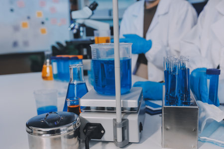 Collaboration, tablet or science with people in lab together for research or development. Innovation, tech and microscope with scientist team in clinical trial for planning or medical investigationの写真素材