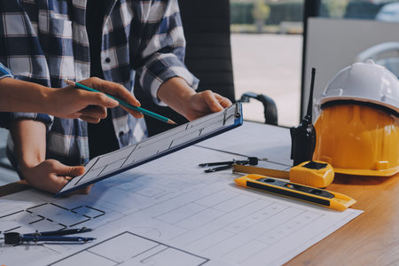 Construction and structure concept of engineer working drawing on blueprint meeting for project...